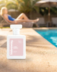 hideaway. Ivory Bloom perfume 50ml bottle on a sunlit pool ledge on a summer afternoon