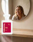 hideaway. Apple Crush perfume 50ml bottle on an oak shelf below a round mirror
