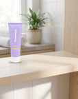 hideaway. Pineapple Coconut Body Wash on a timber bathroom shelf beside rolled towels