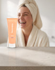hideaway. Black Essence Conditioner on a white shelf in a bright tiled bathroom