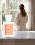 hideaway. Cherry Blaze perfume 50ml bottle on a marble ledge by a sunlit window
