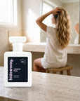 hideaway. Cosmic Kiss perfume 50ml bottle on a travertine vanity while she gets ready in the morning