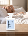 hideaway. Dark Tide perfume 50ml bottle on a bedside table in warm morning light