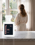 hideaway. Sweet Chaos perfume 50ml bottle on a marble ledge by a sunlit window