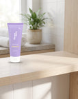 hideaway. Mini Vanilla Delight Shower Mousse on a timber bathroom shelf beside rolled towels