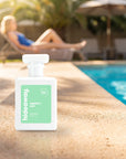 hideaway. Perfect Day perfume 50ml bottle on a sunlit pool ledge on a summer afternoon