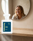 hideaway. Tonka Touch perfume 50ml bottle on an oak shelf below a round mirror