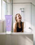 hideaway. Black Essence Body Scrub on a shower ledge in a bright bathroom