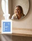 hideaway. Darling Belle perfume 50ml bottle on an oak shelf below a round mirror