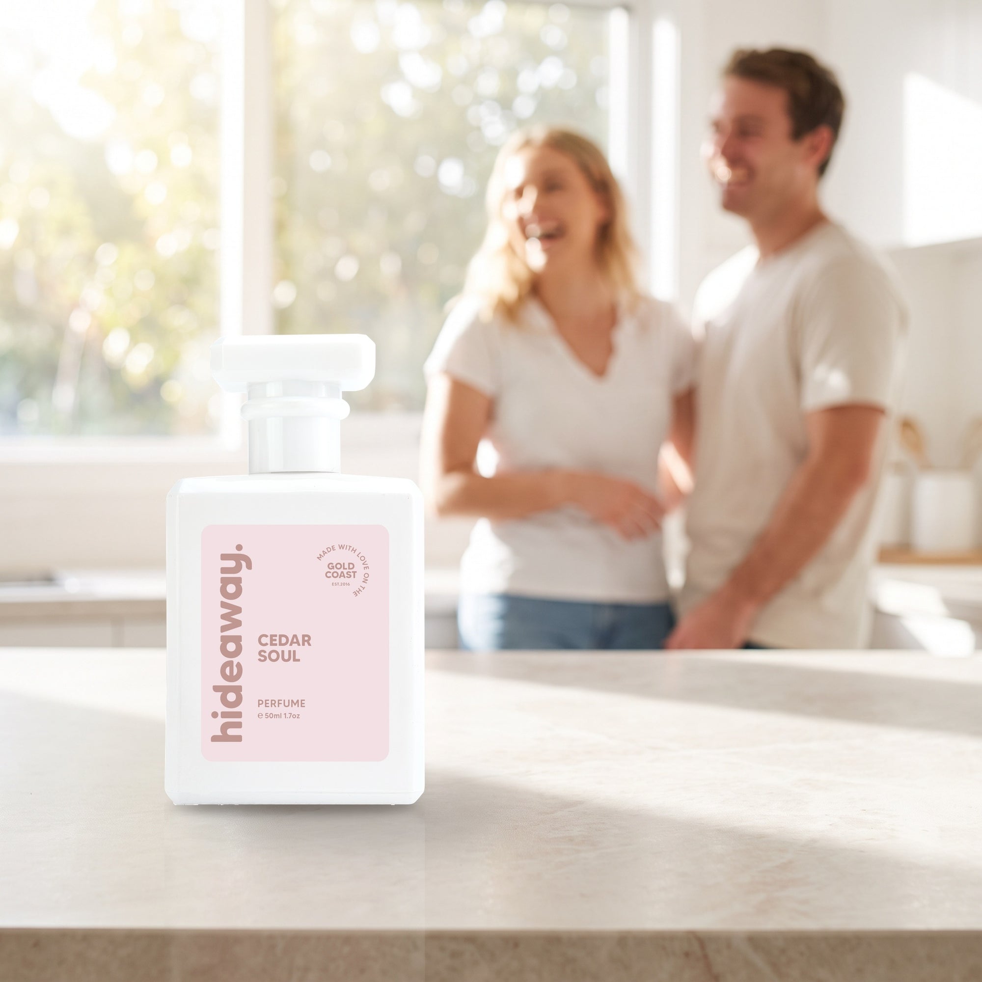 hideaway. Cedar Soul perfume 50ml bottle on a stone benchtop in a bright kitchen
