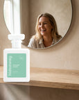 hideaway. Heaven Scent perfume 50ml bottle on an oak shelf below a round mirror