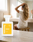 hideaway. Pineapple Coconut perfume 50ml bottle on a travertine vanity while she gets ready in the morning