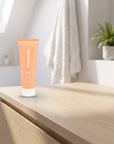 hideaway. Vanilla Delight Shampoo on a pale timber vanity top in a bright bathroom