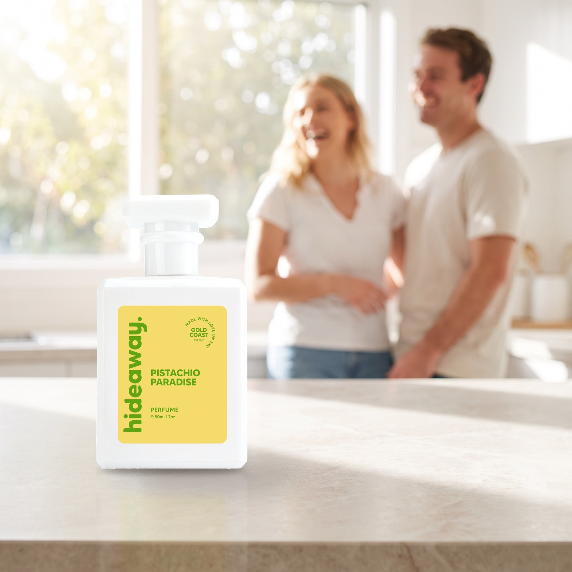 hideaway. Pistachio Paradise perfume 50ml bottle on a stone benchtop in a bright kitchen