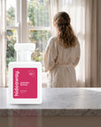 hideaway. Aurora Rouge perfume 50ml bottle on a marble ledge by a sunlit window