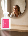 hideaway. Pink Spice perfume 50ml bottle on an oak shelf below a round mirror