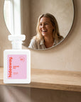 hideaway. Sugar Fix perfume 50ml bottle on an oak shelf below a round mirror