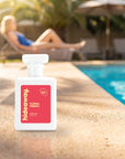 hideaway. Floral Frenzy perfume 50ml bottle on a sunlit pool ledge on a summer afternoon