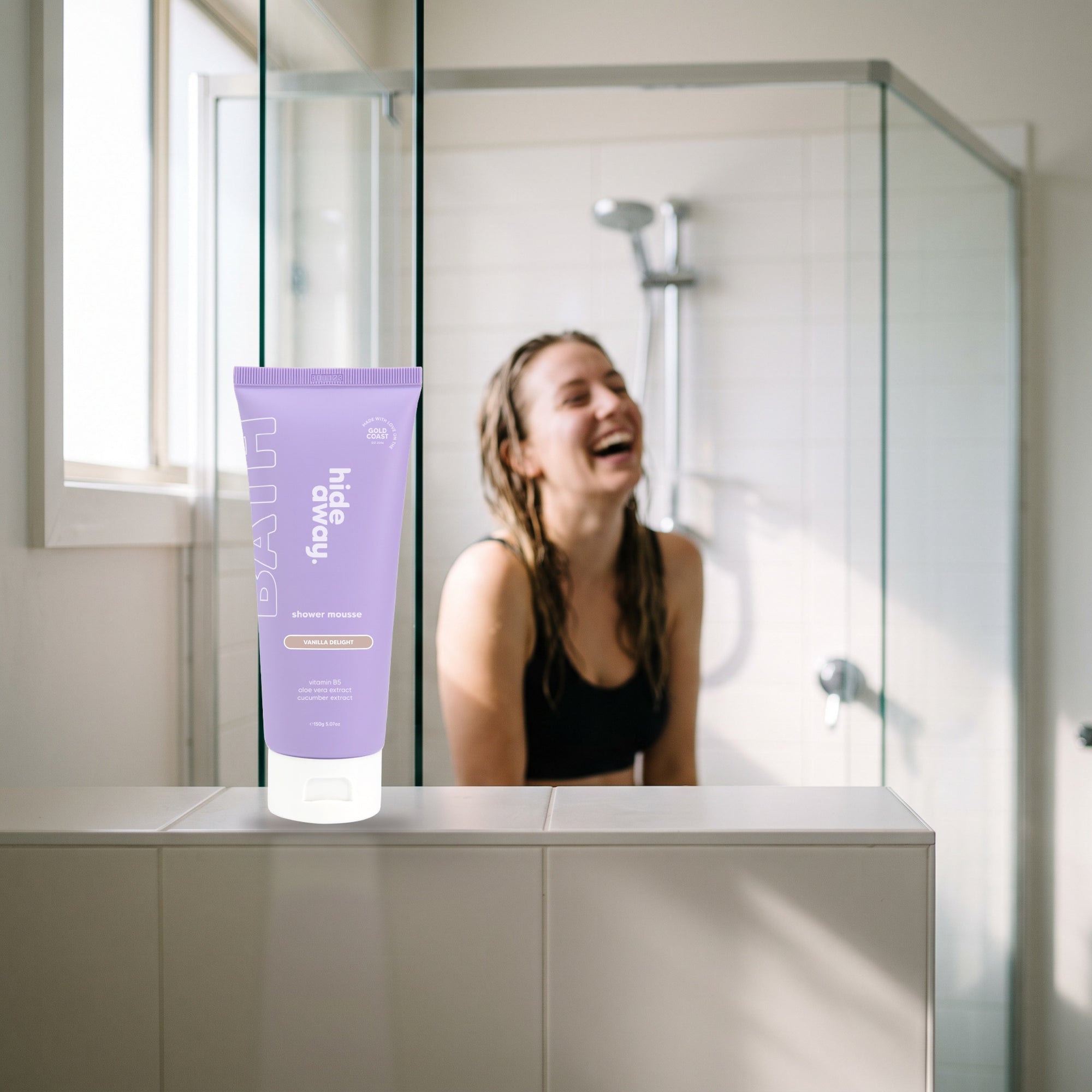 hideaway. Vanilla Delight Shower Mousse on a white shelf in a bright tiled bathroom