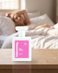 hideaway. Pink Candy perfume 50ml bottle on a bedside table in warm morning light