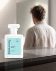 hideaway. Ocean Blue perfume 50ml bottle on a stone dresser in soft morning light