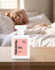 hideaway. Black Essence perfume 50ml bottle on a bedside table in warm morning light
