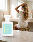 hideaway. Beachside Babe perfume 50ml bottle on a travertine vanity while she gets ready in the morning