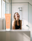 hideaway. Mini Vanilla Delight Shampoo on a shower ledge in a bright bathroom