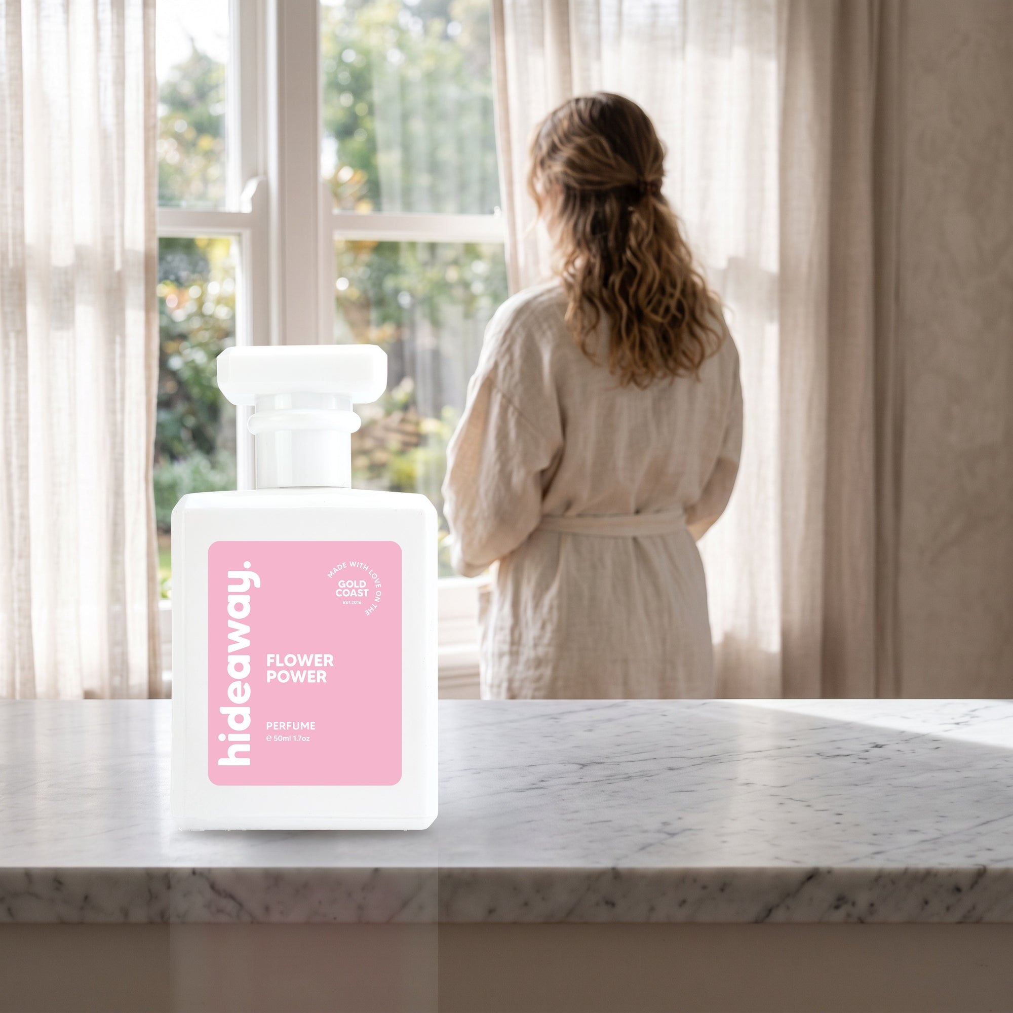 hideaway. Flower Power perfume 50ml bottle on a marble ledge by a sunlit window