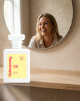 hideaway. Flora Fever perfume 50ml bottle on an oak shelf below a round mirror