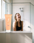 hideaway. Black Essence Hair Mask on a shower ledge in a bright bathroom
