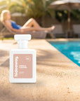 hideaway. Vanilla Caramel perfume 50ml bottle on a sunlit pool ledge on a summer afternoon
