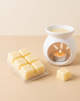 Vanilla Caramel wax melt pack with a single cube and a lit ceramic burner showing how wax melts are used